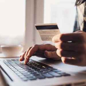 Man,Holding,Credit,Card,And,Using,Laptop.,Businessman,Or,Entrepreneur